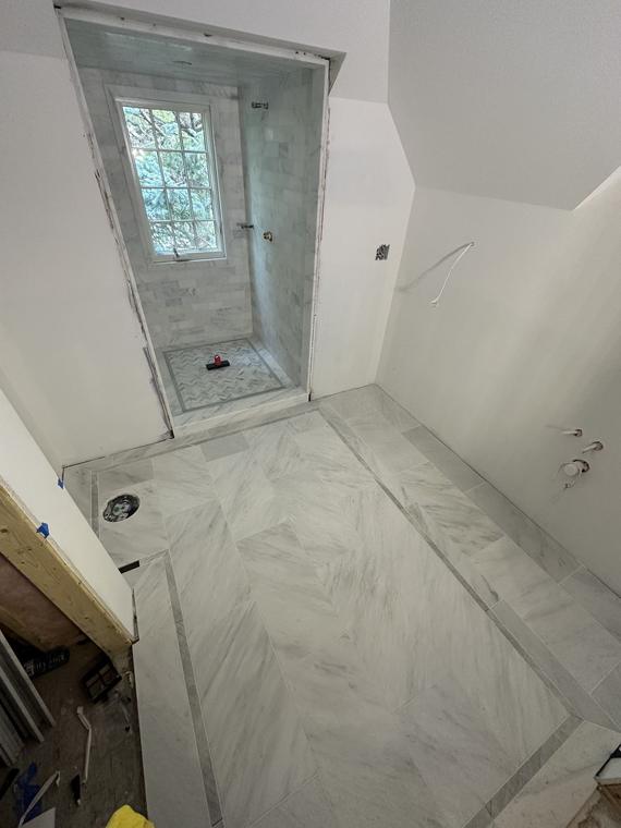 Marble bathroom floor with a contrasting border inlay